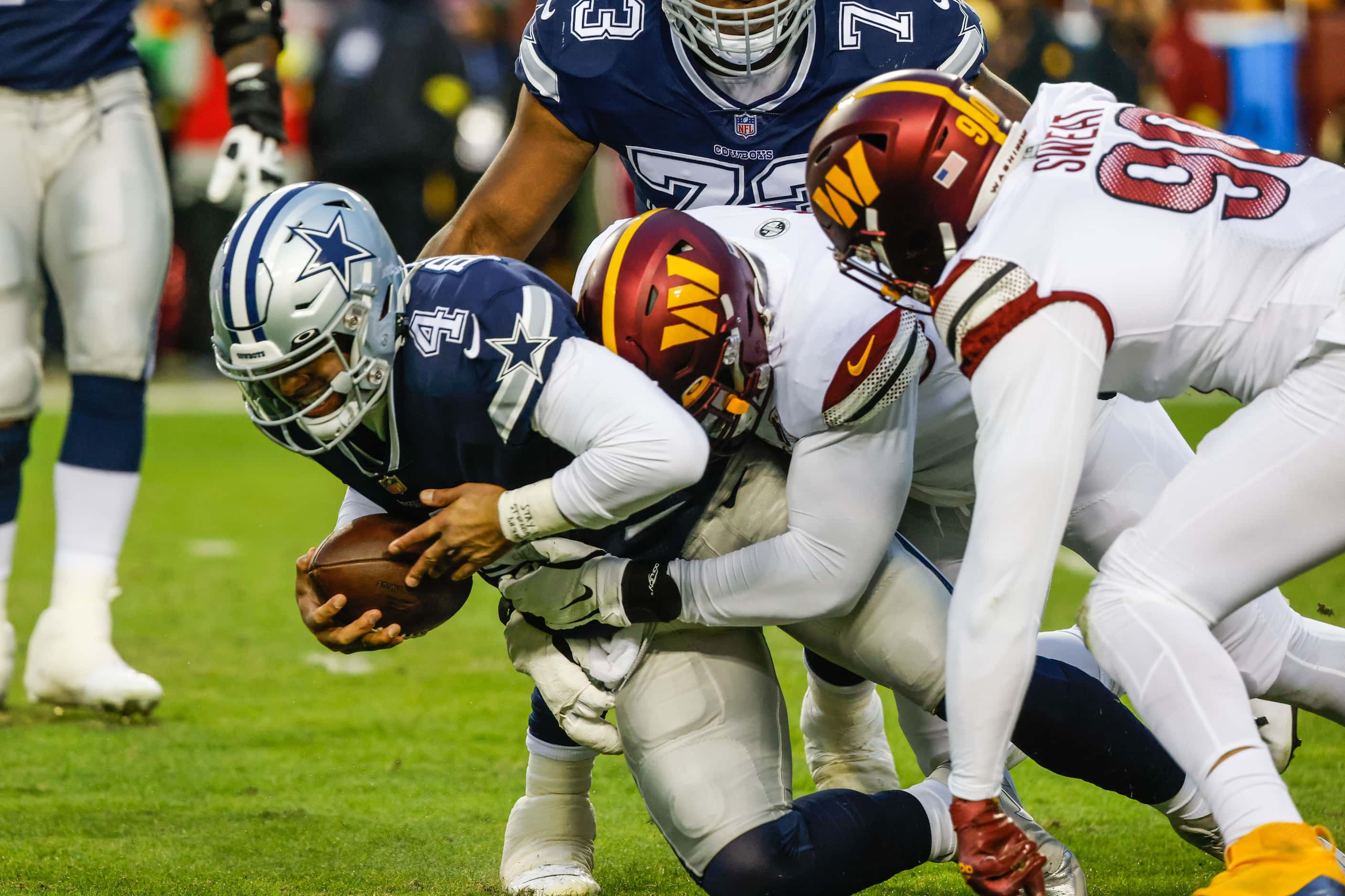 Dallas Cowboys quarterback Dak Prescott (4) gets sacked by Washington Commanders defensive...