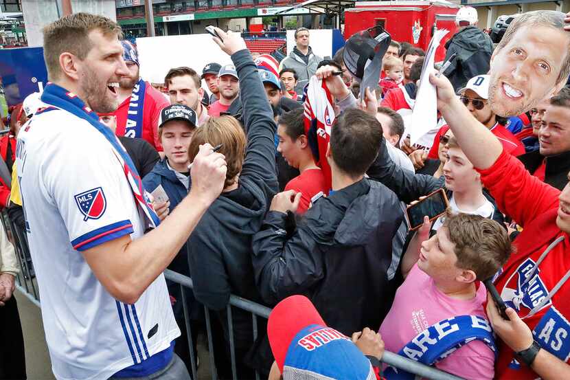 Dirk Nowitzki signs autographs before the start of the game as FC Dallas hosted the New York...