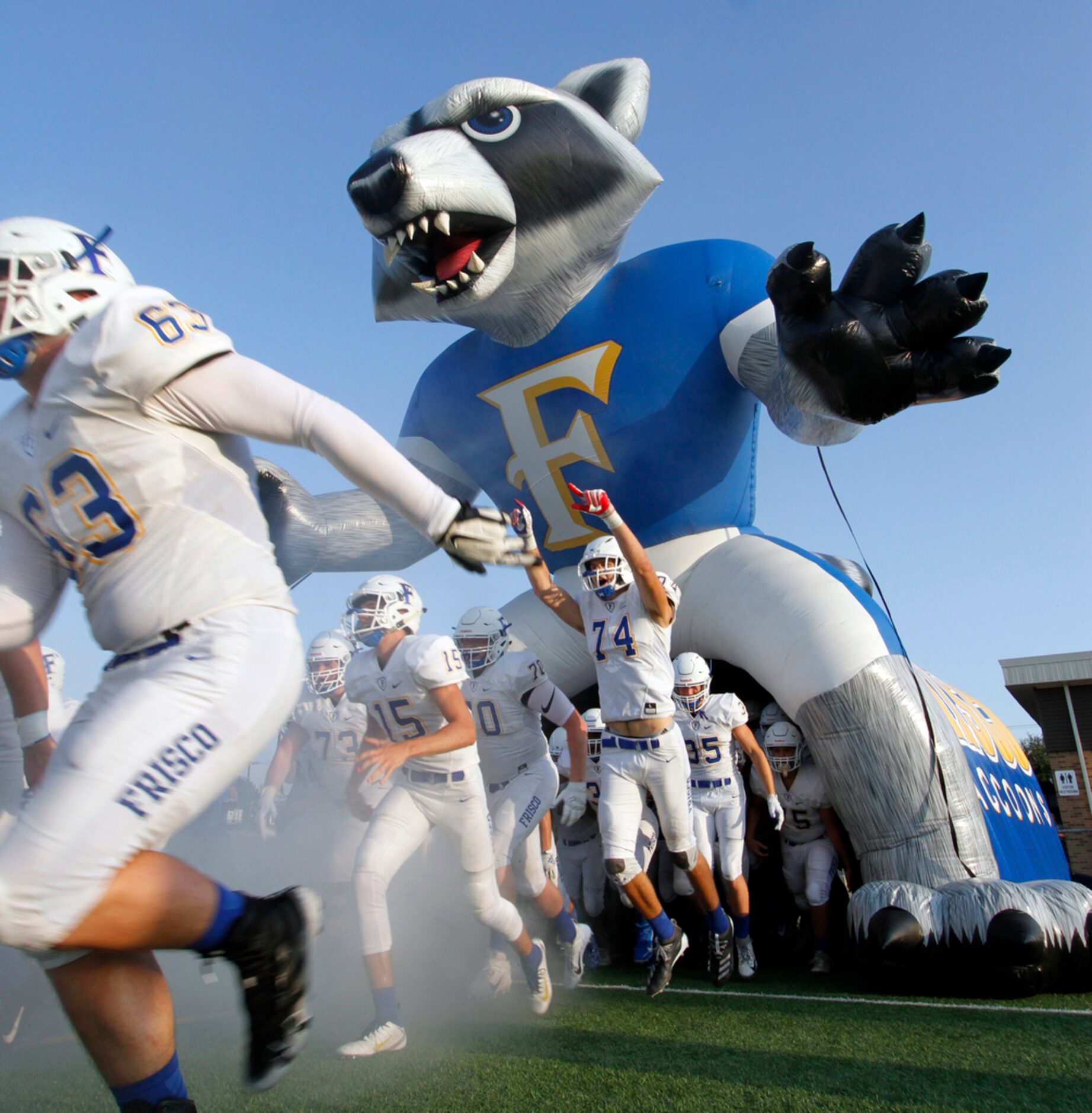 Frisco offensive lineman John Lilly (74) leaps with excitement as he and Raccoon teammates...