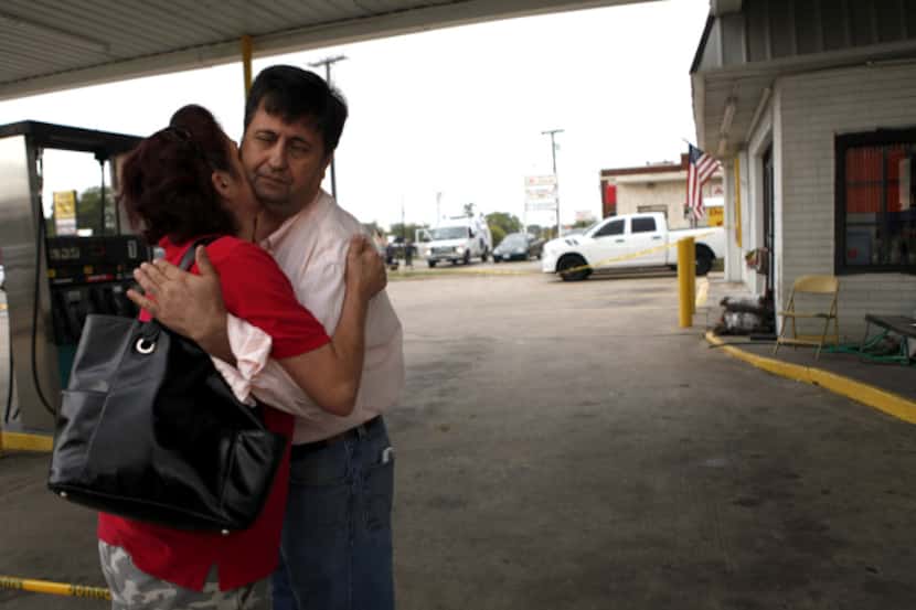 Owner of Ali's Market Ali Karimi, right, hugs Rosie Paup who works at a nearby business on...