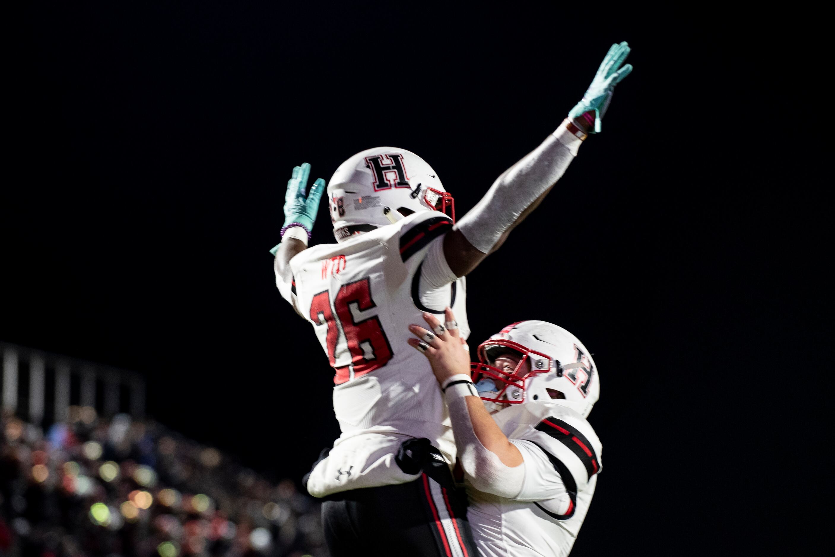 Heath senior Zach Evans (26) is hoisted in the air by Heath sophomore Cash Cleveland (56)...