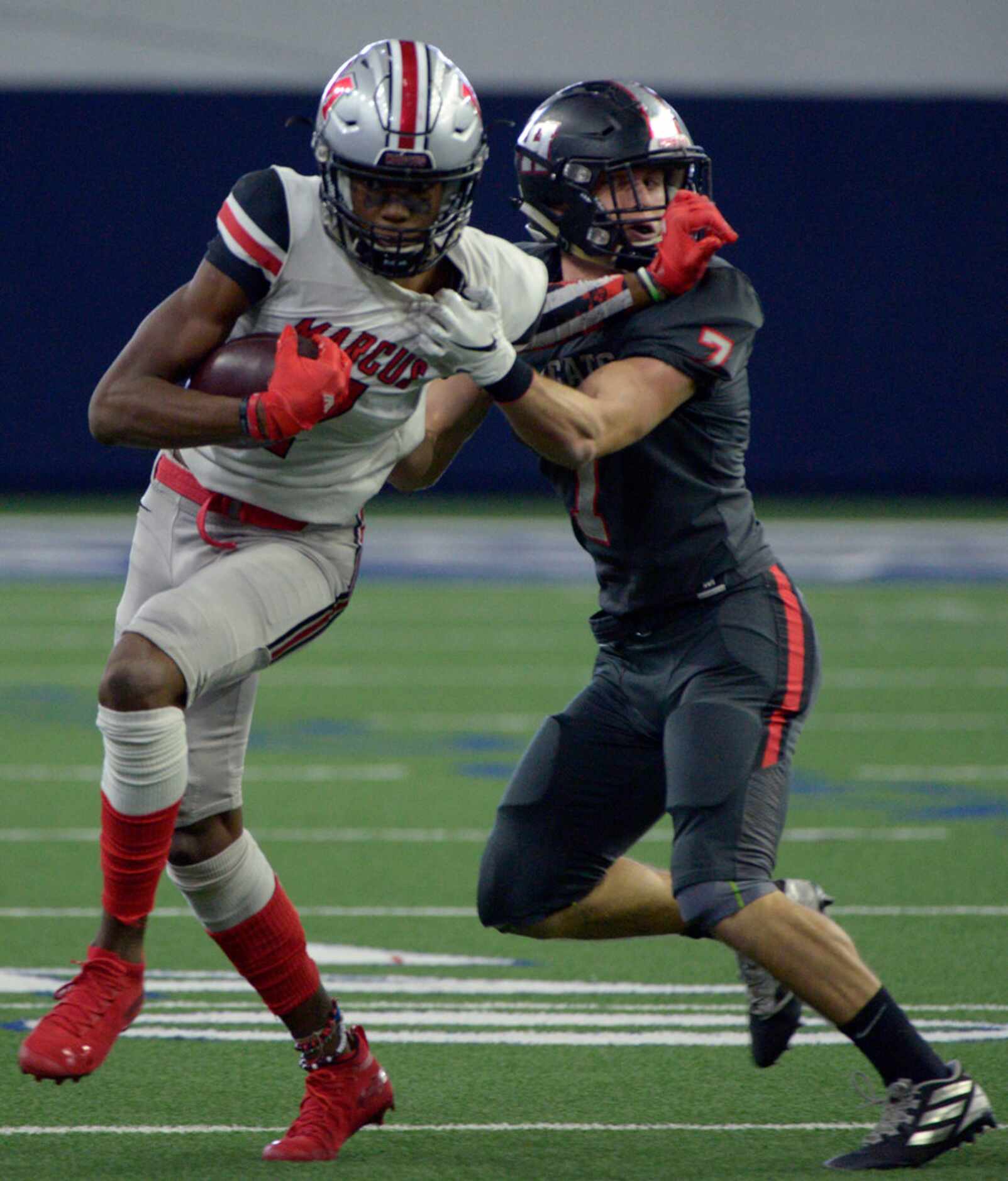 Flower Mound Marcus' J. Michael Sturdivant stiff arms Lake Highlands Caleb Parker (7) in the...