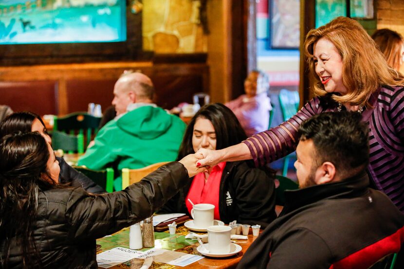 Dallas mayoral candidate Regina Montoya (right) introduces herself to Blanca Berlanda during...