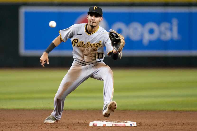 FILE - Pittsburgh Pirates shortstop Tucupita Marcano takes a throw down to second base...