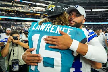 Dallas Cowboys quarterback Dak Prescott hugs Jacksonville Jaguars quarterback Trevor...
