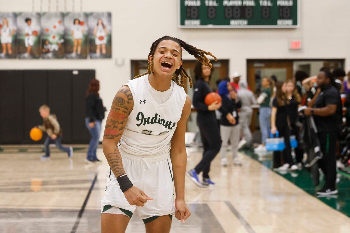 Waxahachie high’s Shawn Blakemore cheers after winning a basketball game against Mansfield...