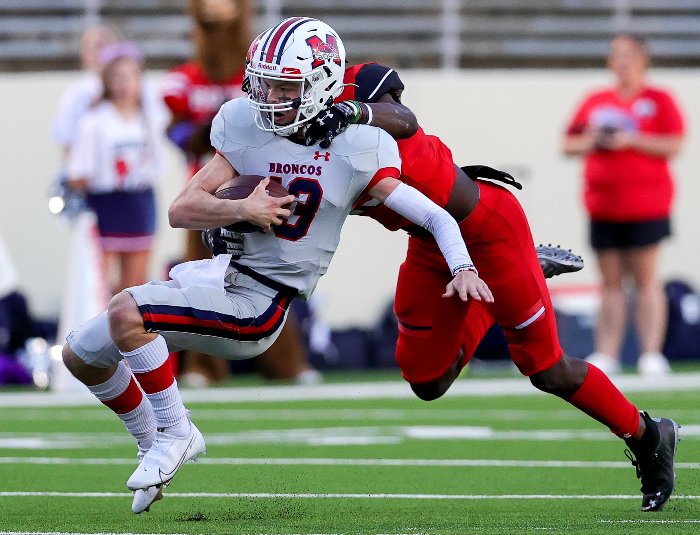 McKinney Boyd quarterback Ryan Shackleton (13) gets tackled on the play by Denton Braswell...