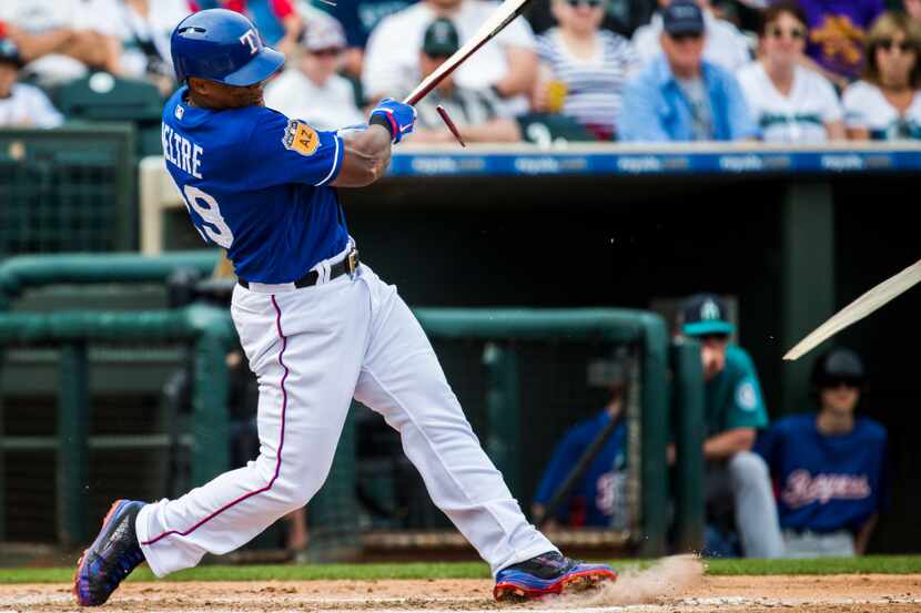 Texas Rangers third baseman Adrian Beltre (29) breaks a bat during the third inning of a...