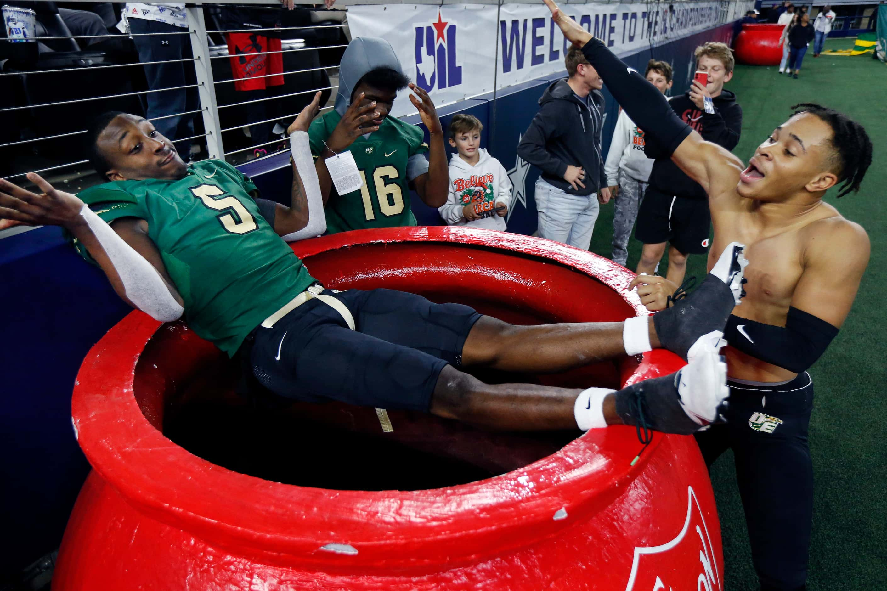 DeSoto football players Makali McKellar (right) celebrates with Tre Wisner (5) after their A...