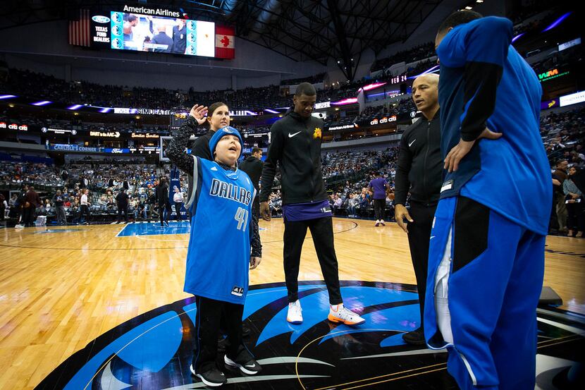 Make-A-Wish youngster Rutger McCrum waves to the crowd as he his introduced as the honorary...