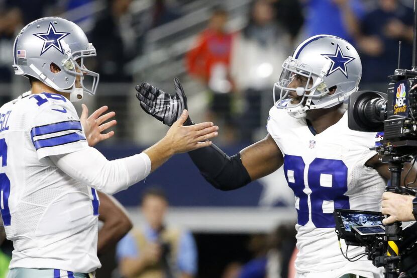 Dallas Cowboys wide receiver Dez Bryant (88) is congratulated by quarterback Matt Cassel...