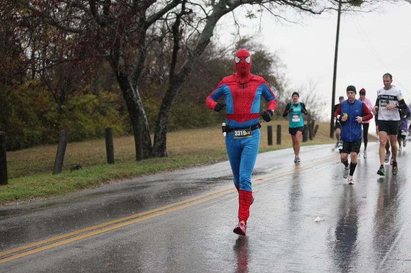 Richard Hensser of Dallas runs in his Spiderman costume to the 21st mile mark at the lake...