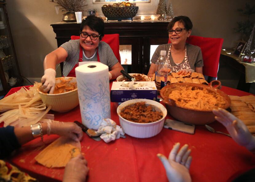 Yolanda Dimas (left) and her sister Liz Walker make tamales with their family.