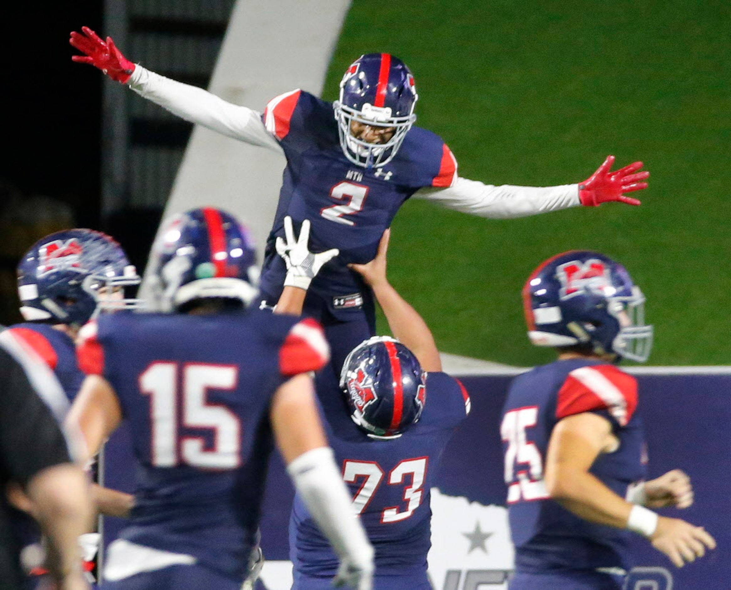 McKinney Boyd's Ja Tyler Shaw (2) celebrates his third-quarter touchdown with teammates...