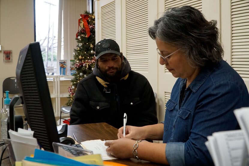 Fernando Quintero gets assistance from Patty Quintana at Mission Oak Cliff in Dallas on...