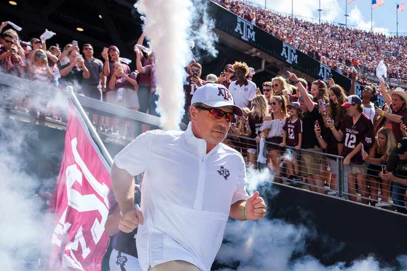 Texas A&M head coach Jimbo Fisher leads his team as they take the field to face Auburn in an...