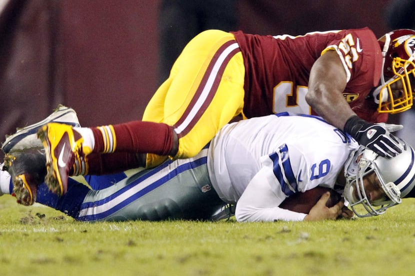 Dallas Cowboys quarterback Tony Romo (9) is sacked by Washington Redskins inside linebacker...