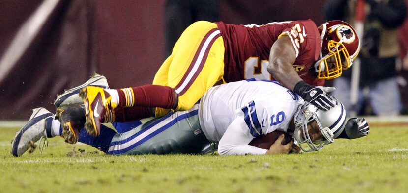 Dallas Cowboys quarterback Tony Romo (9) is sacked by Washington Redskins inside linebacker...