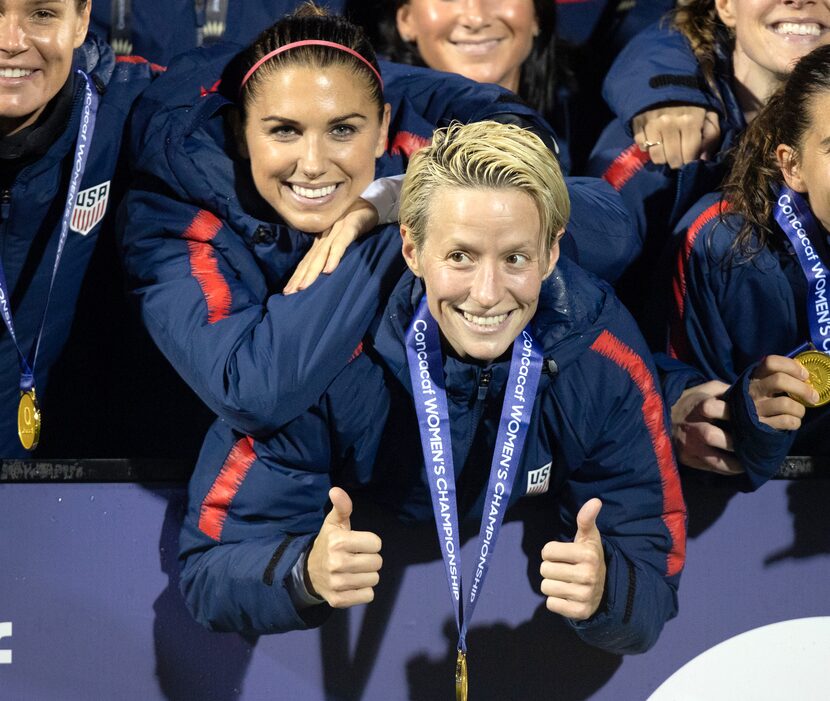 FRISCO TX - OCTOBER 17: USA forwards Alex Morgan and Megan Rapinoe celebrate after receiving...