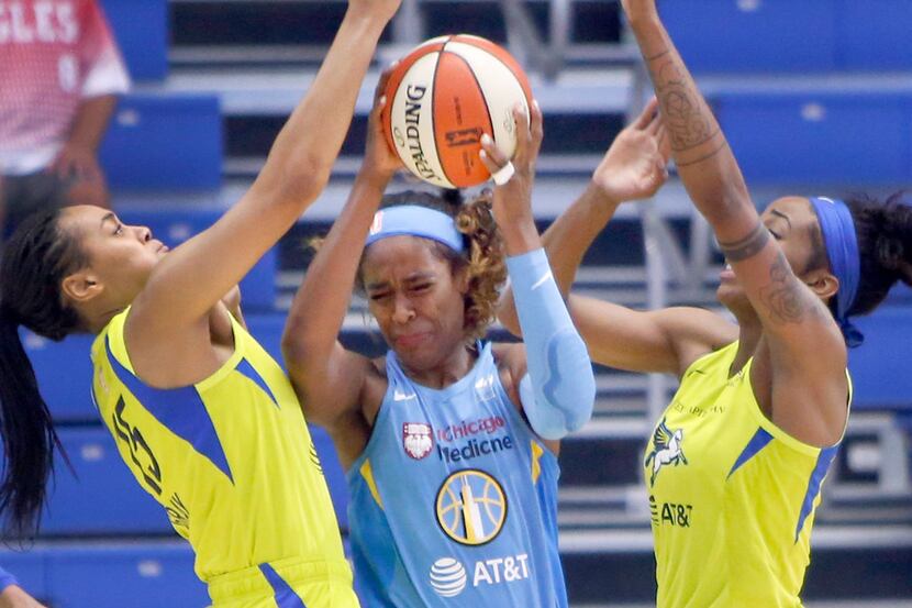 Chicago Sky forward Cheyenne Parker (32), center, feels the defensive pressure applied by...