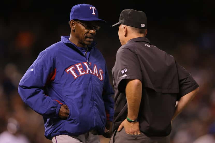 DENVER, CO - MAY 06:  Manager Ron Washington #38 of the Texas Rangers challenges a call with...