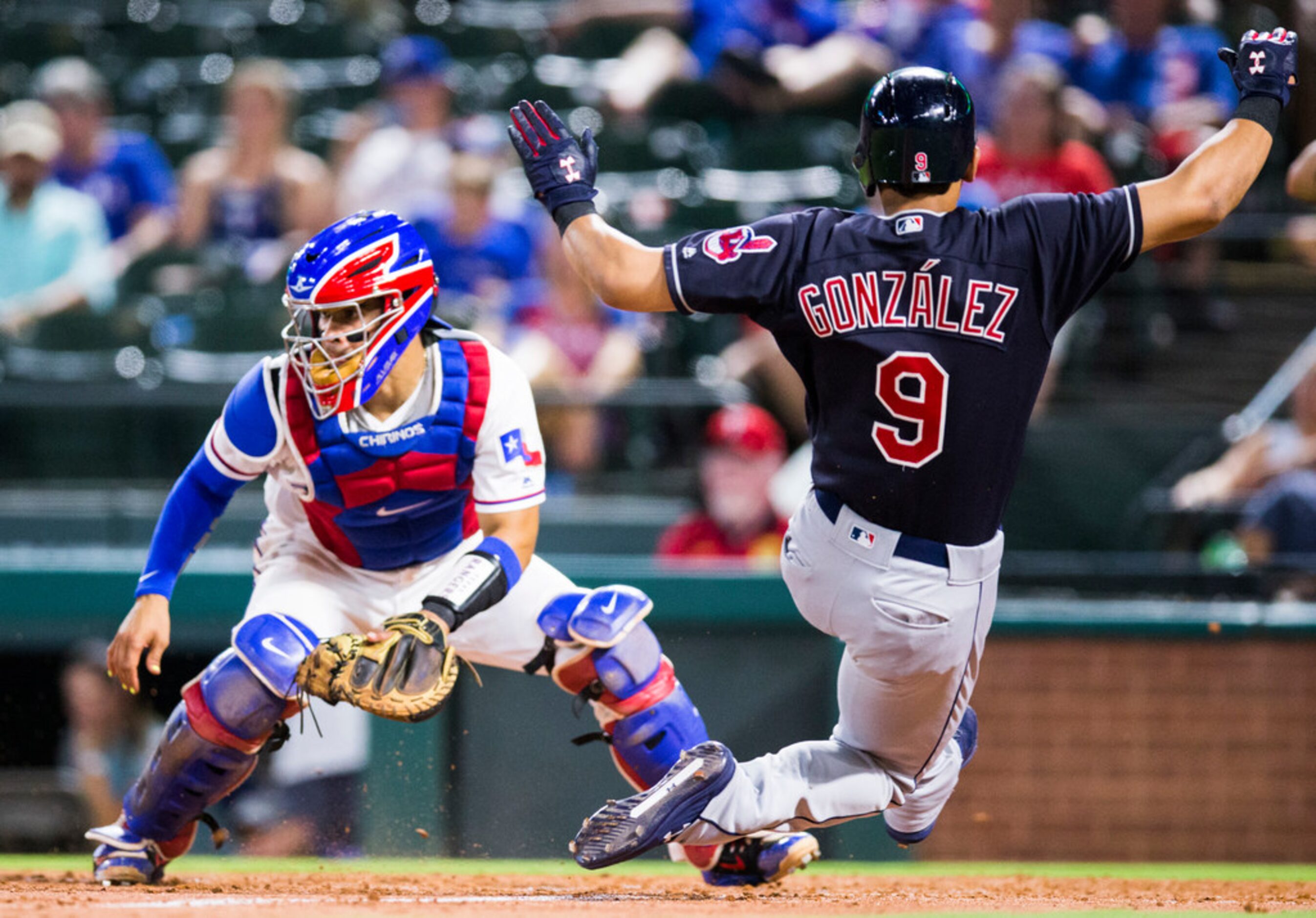 Texas Rangers catcher Robinson Chirinos (61) waits for a throw to home plate as Cleveland...