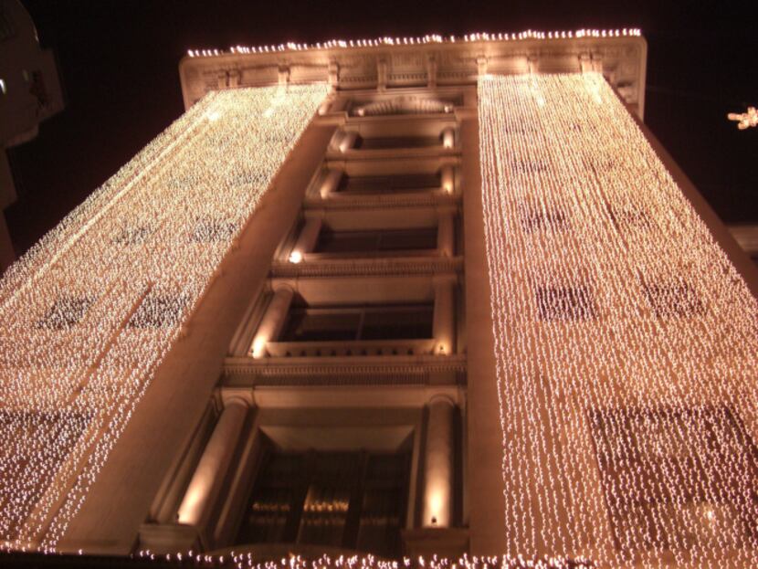 Outside The Peninsula hotel, decorative lights take on a holiday flair as do many hotels in...