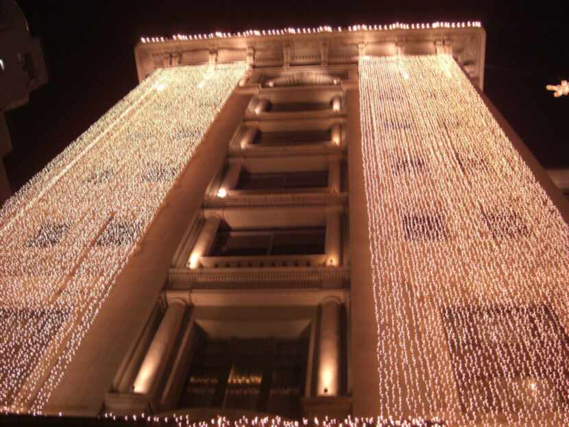Outside The Peninsula hotel, decorative lights take on a holiday flair as do many hotels in...