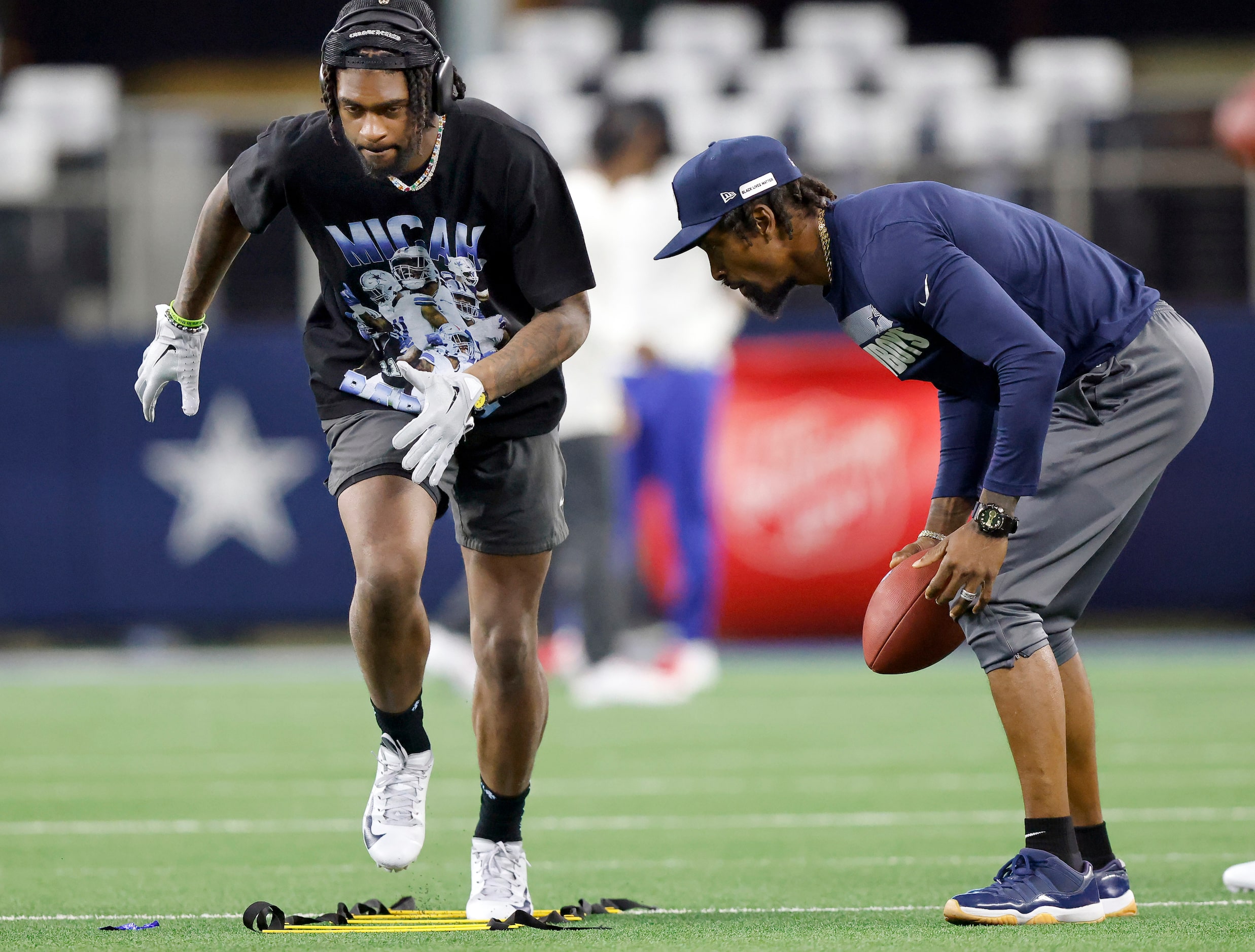 Dallas Cowboys cornerback Trevon Diggs (left) works out in a Micah Parsons t-shirt during...