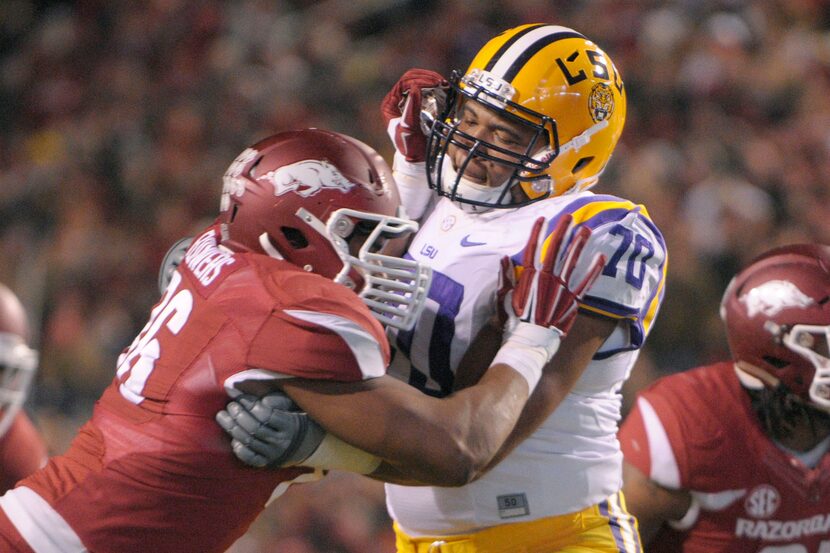 LSU offensive tackle La'El Collins (70) and Arkansas defensive end Trey Flowers face off in...