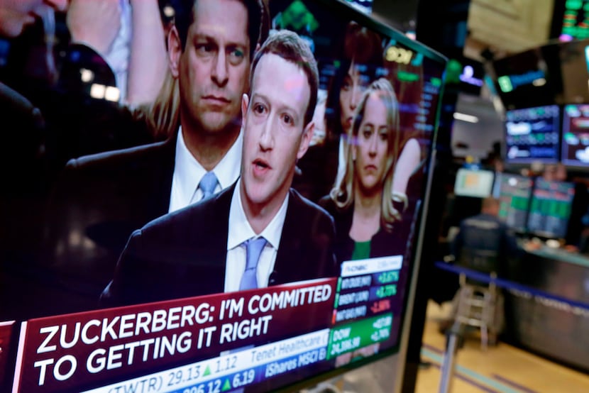  Facebook CEO Mark Zuckerberg appears on a television screen on the floor of the New York...