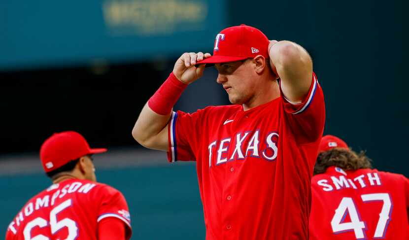 Texas Rangers third baseman Josh Jung (6) puts his hat back on following the National Anthem...