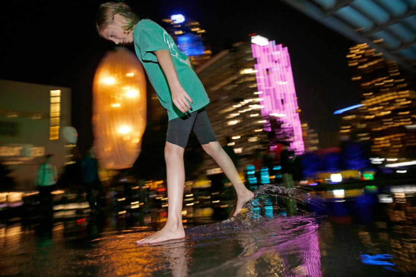 Paige Idleman, 11, dances on the reflecting pool next to an artwork called 'Unwind' by...