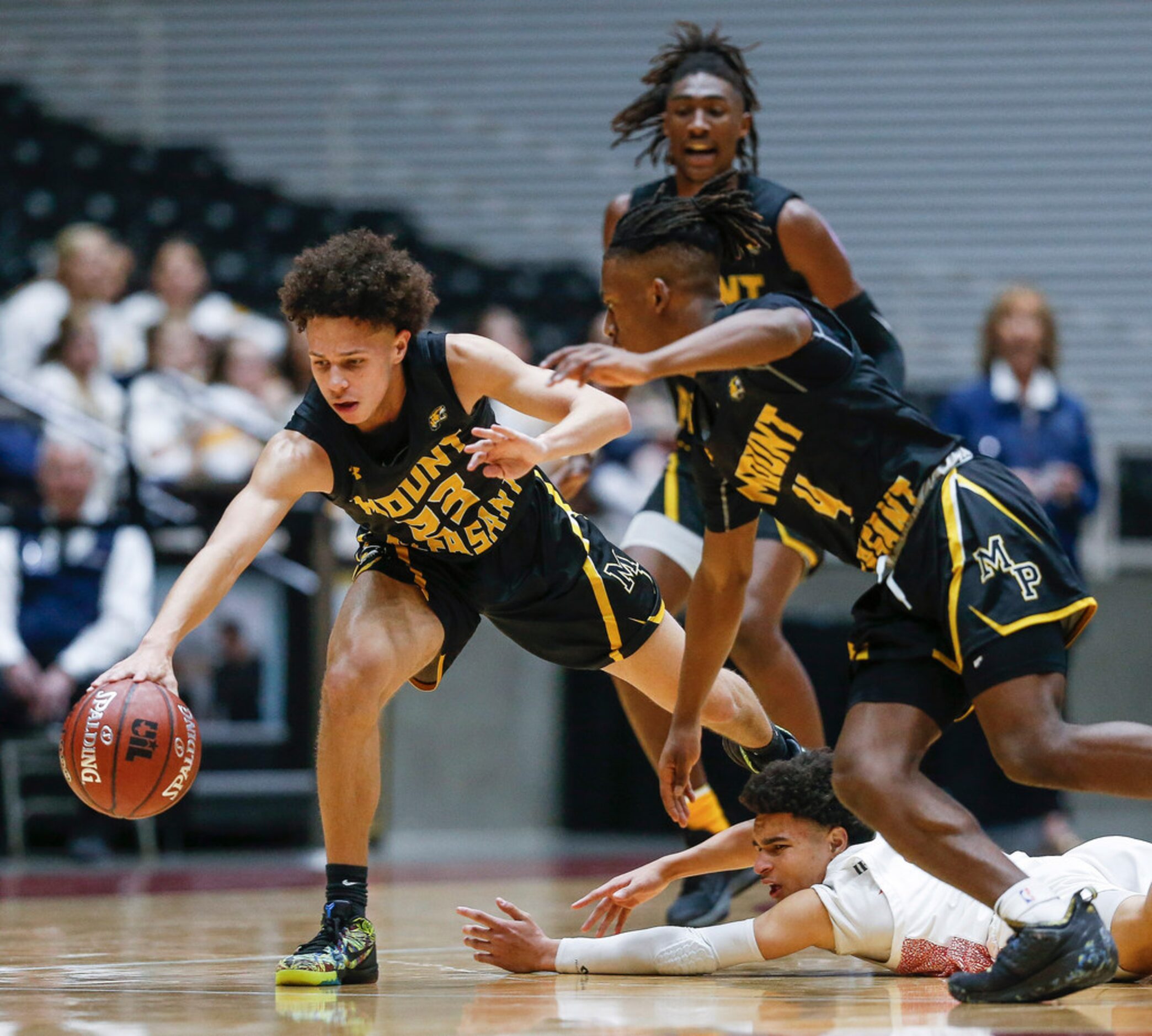 Kimball's Jayden Blair (10) reaches to recover a loose ball against Mount Pleasant's Payton...