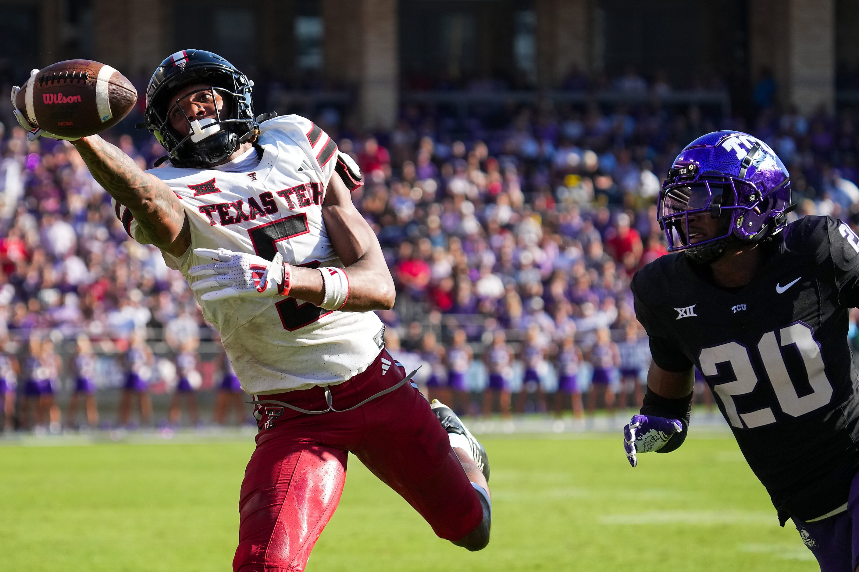 A pass goes off the fingertips of Texas Tech wide receiver Caleb Douglas (5) as TCU...