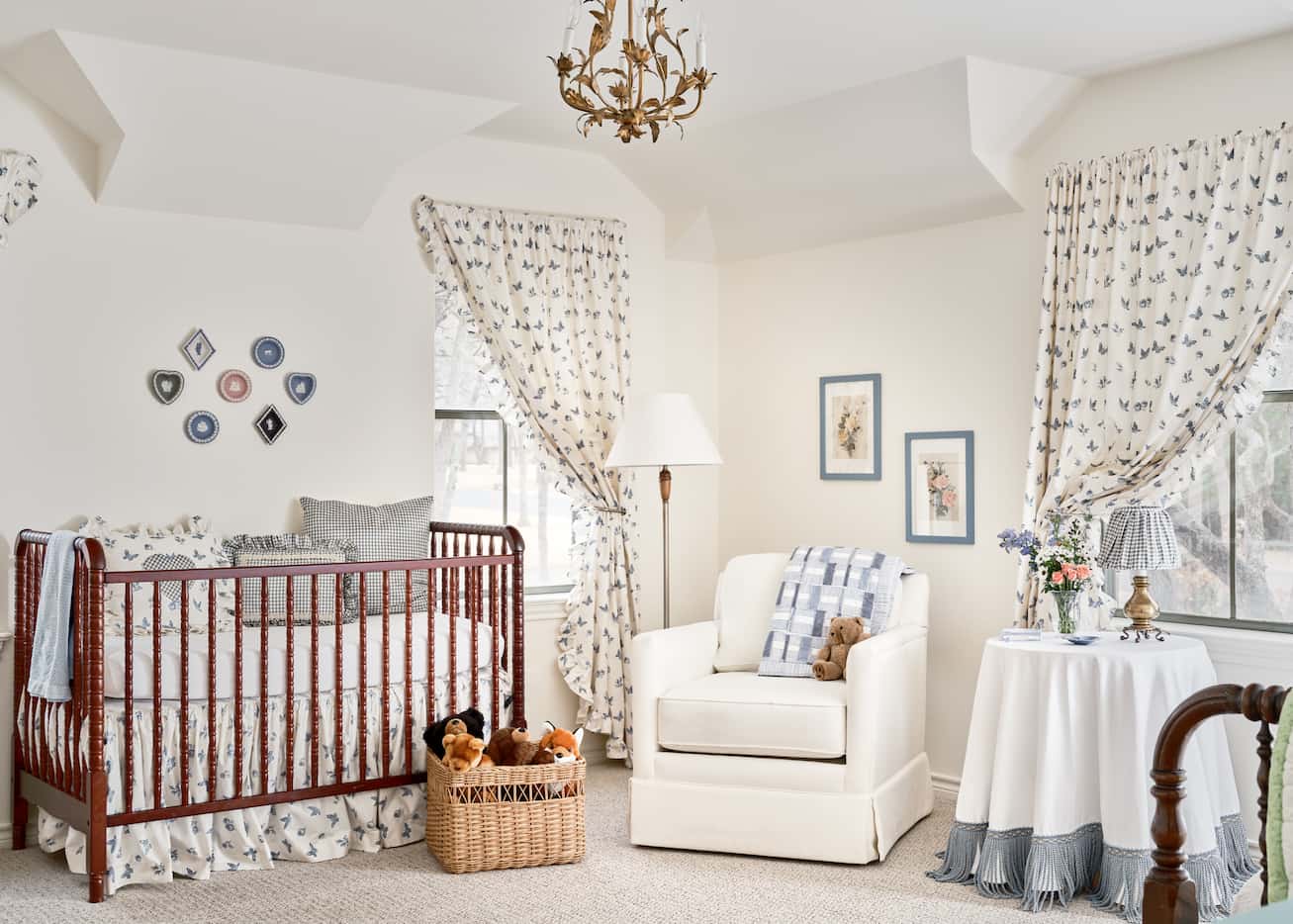 Baby nursery with a blue and white theme and a red crib.