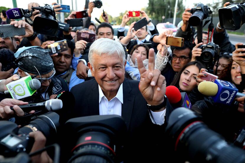 Presidential candidate Andres Manuel Lopez Obrador is greeted by the press as he makes his...