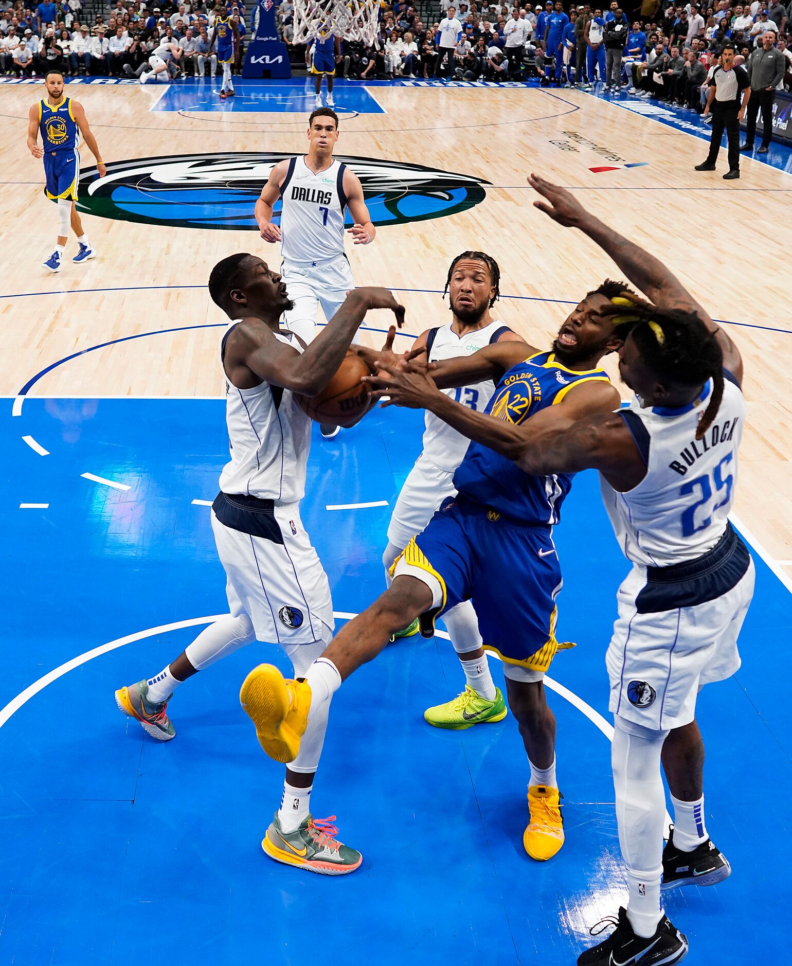 Dallas Mavericks forward Dorian Finney-Smith (10) wrestle a rebound away from Golden State...