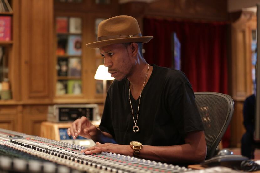 Young Guru mans the sound board at his music studio.