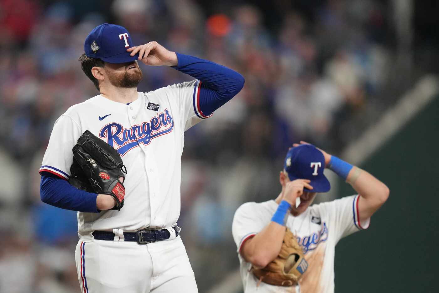 Texas Rangers starting pitcher Jordan Montgomery reacts as manager Bruce Bochy comes to...