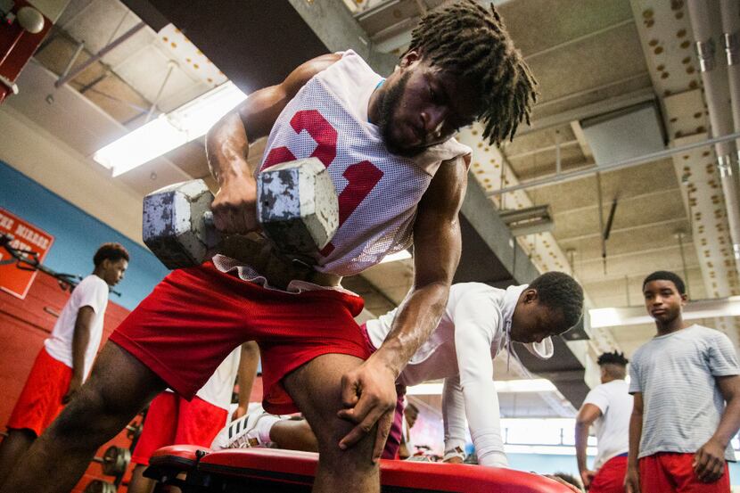Senior running back Odell Foster works out in the weight room during football practice on...