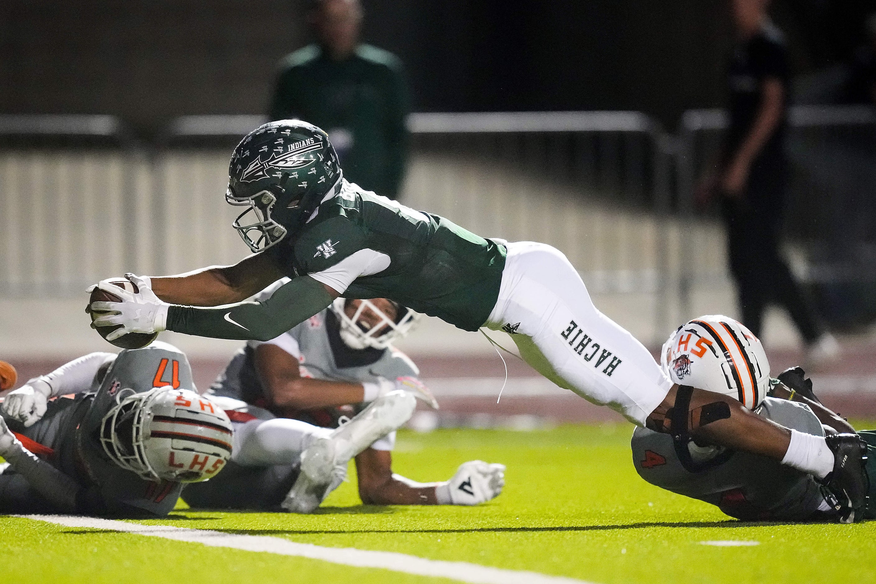 Waxahachie’s Kohen Brown (8) dives for the end zone for a touchdown during the first half of...