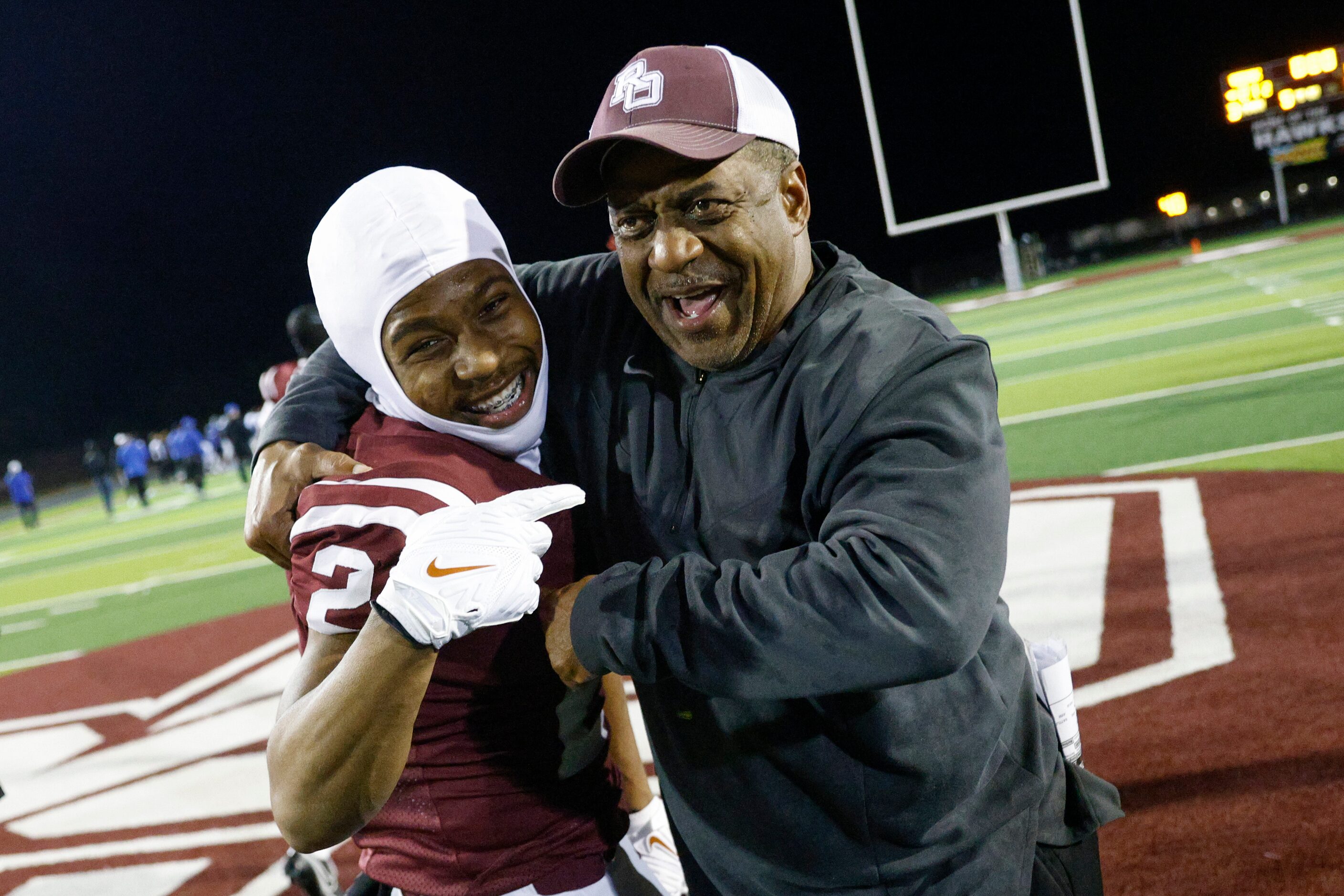 Red Oak head coach Melvin Robinson celebrates with wide receiver Brayden Robinson (2) after...