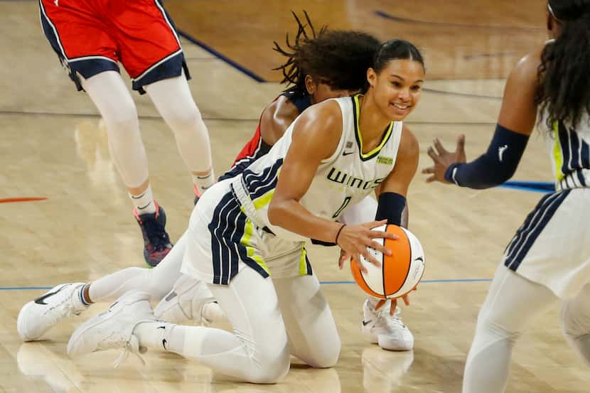 Dallas Wings forward Satou Sabally (0) dives to the floor for a loose ball during the fourth...