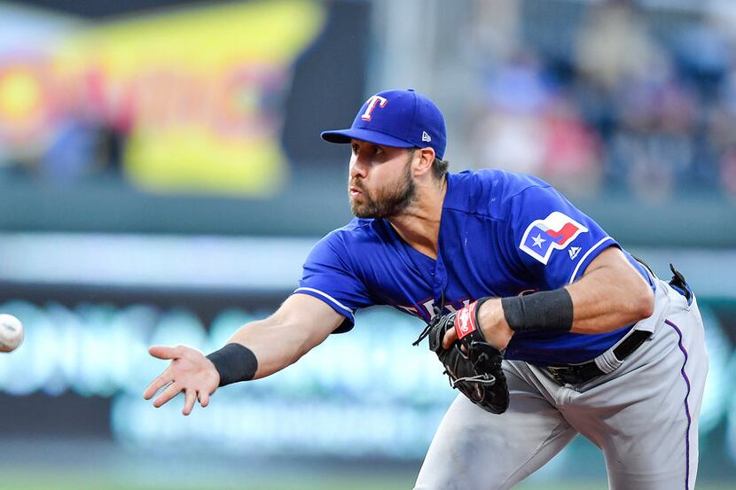Texas Rangers third baseman Joey Gallo tosses a ground out to first for an out on Kansas...