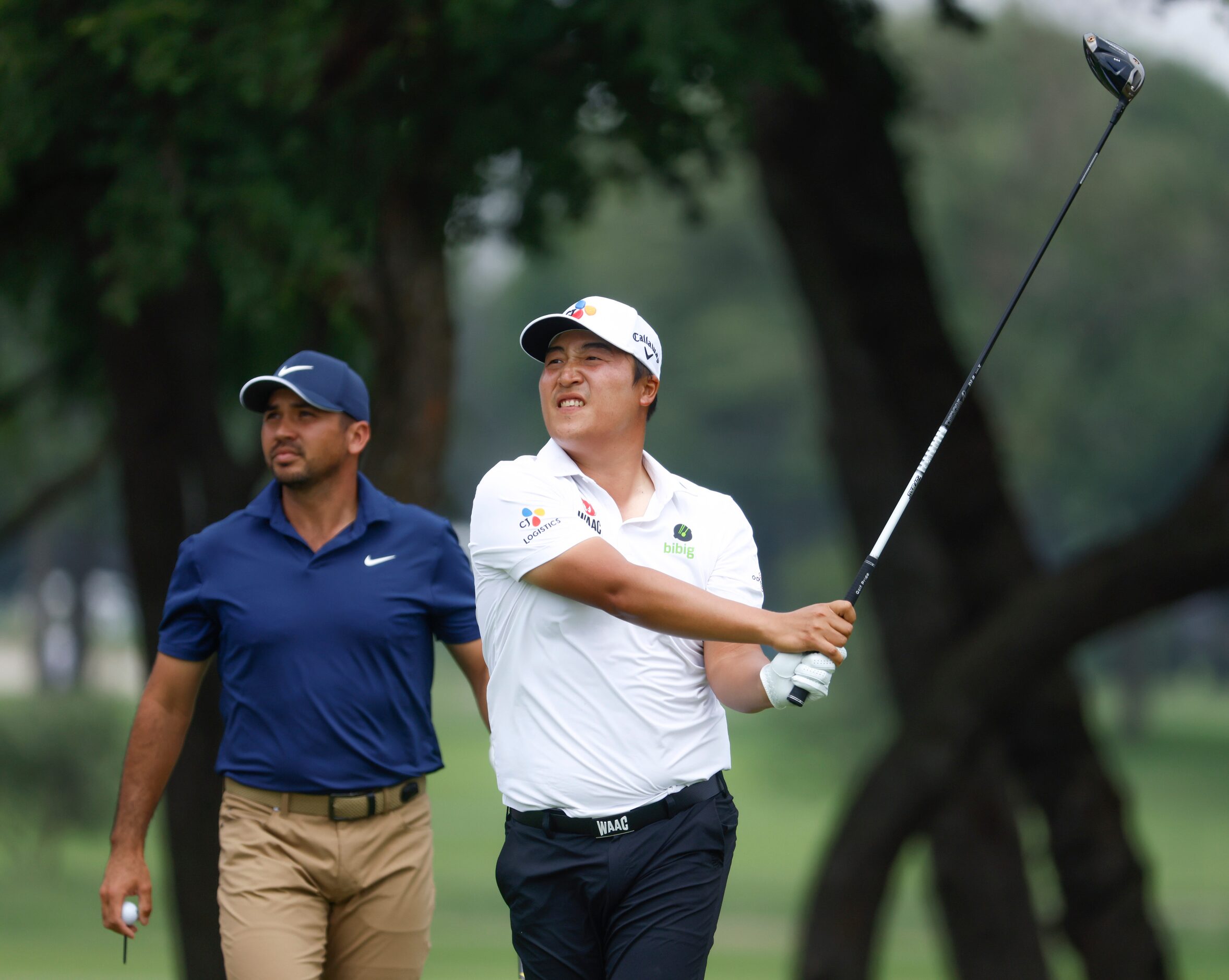 K.H. Lee tees off on the ninth hole as Jason Day (left) watches during the second round of...