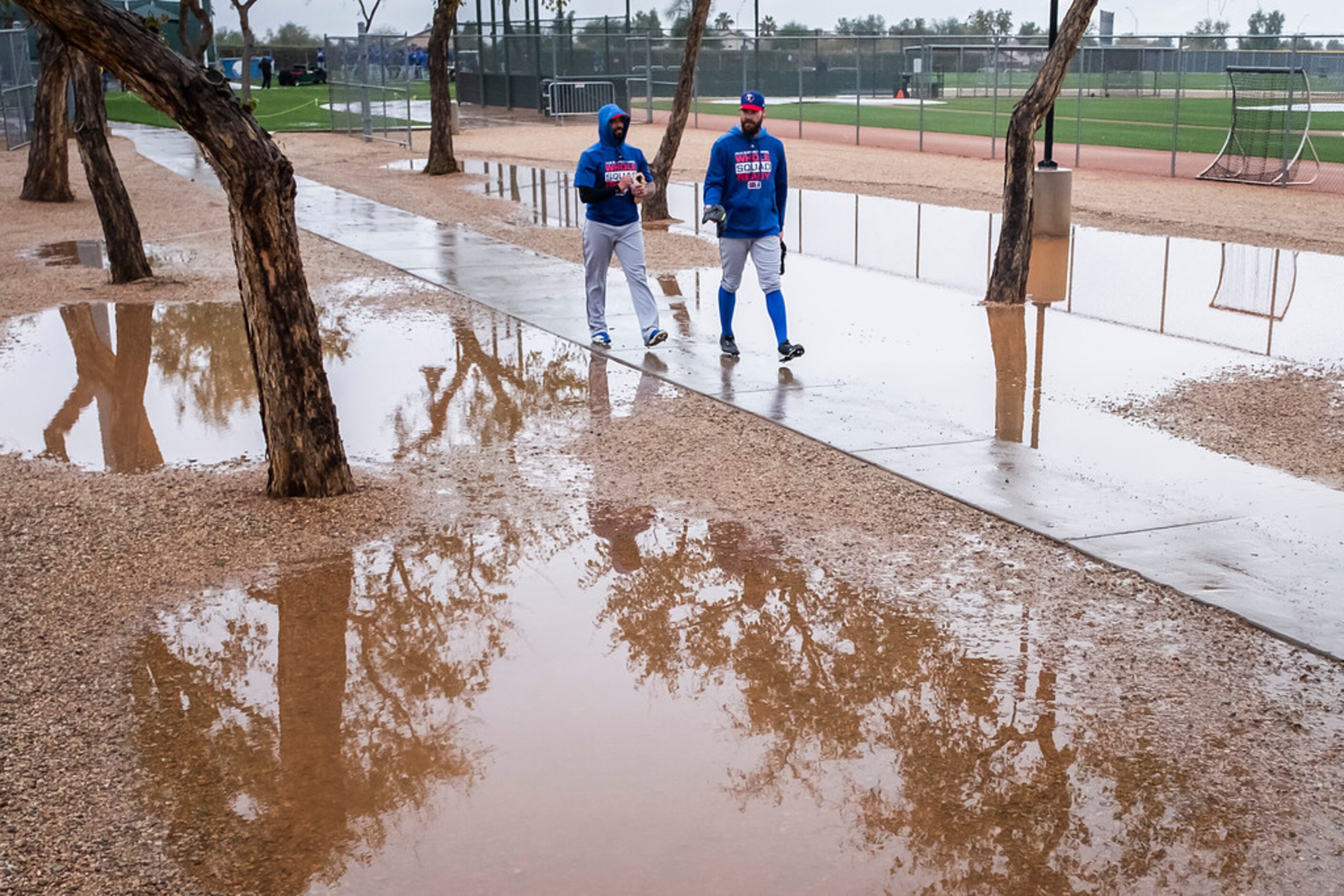 Texas Rangers pitchers Matt Bush (left) and Tim Dillard walk between practice fields during...