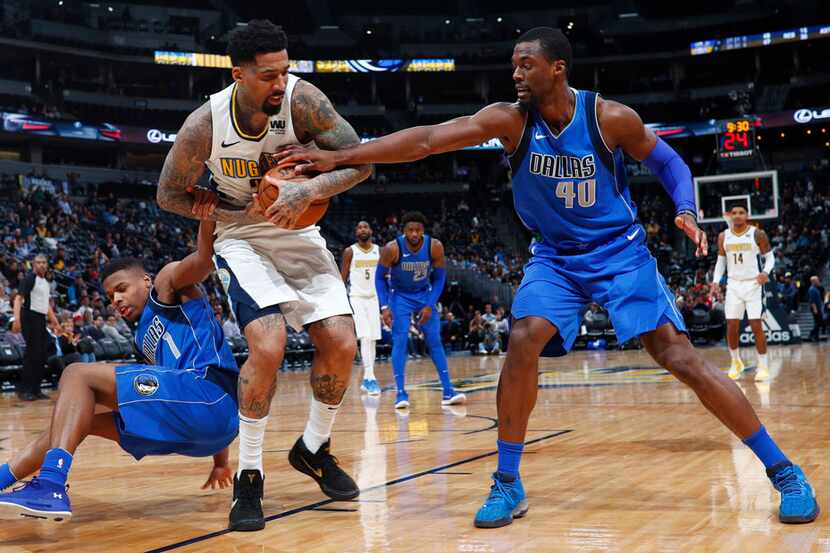 Denver Nuggets forward Wilson Chandler, center, fights for control of a loose ball with...