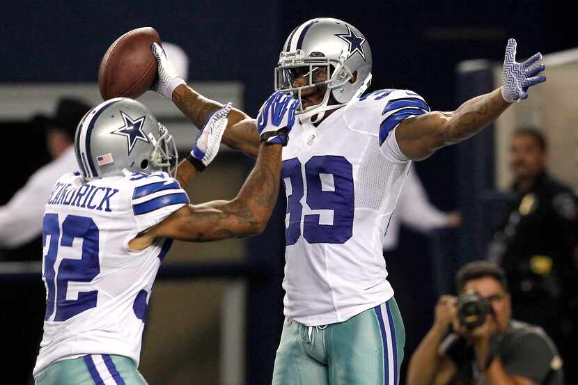 Cowboys cornerback Brandon Carr (right) celebrates an interception return for a touchdown...