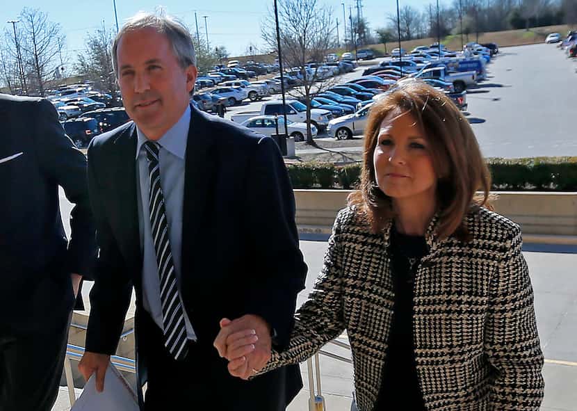 Texas Attorney General Ken Paxton (left) arrived at the Collin County Courthouse with his...